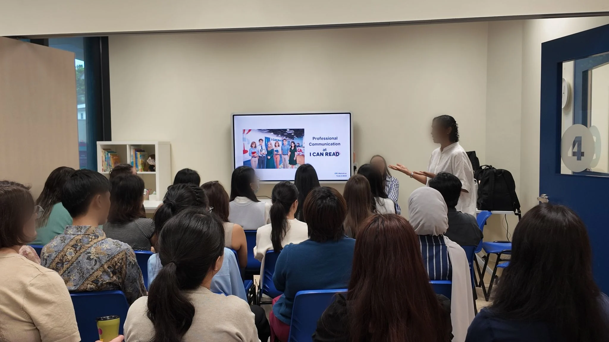 I Can Read teachers at a professional development workshop, with a large screen at the front of the room.